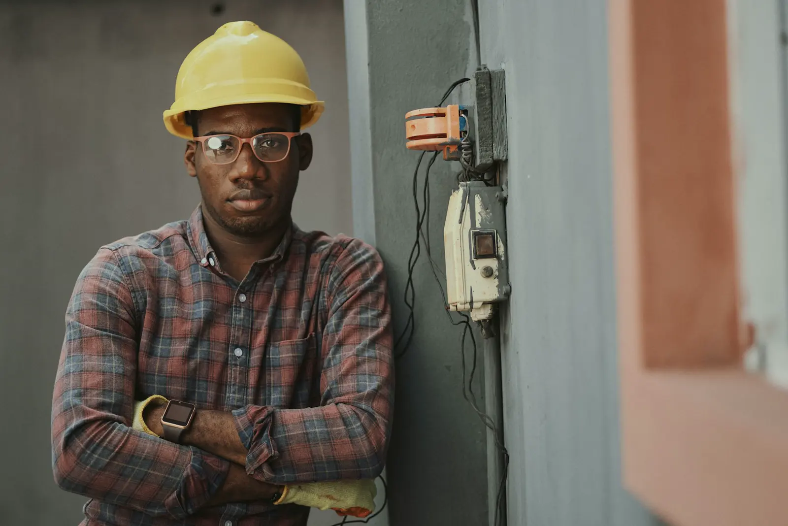 Stock photo of a tradesperson in a hard hat reviewing a job, used on the about page