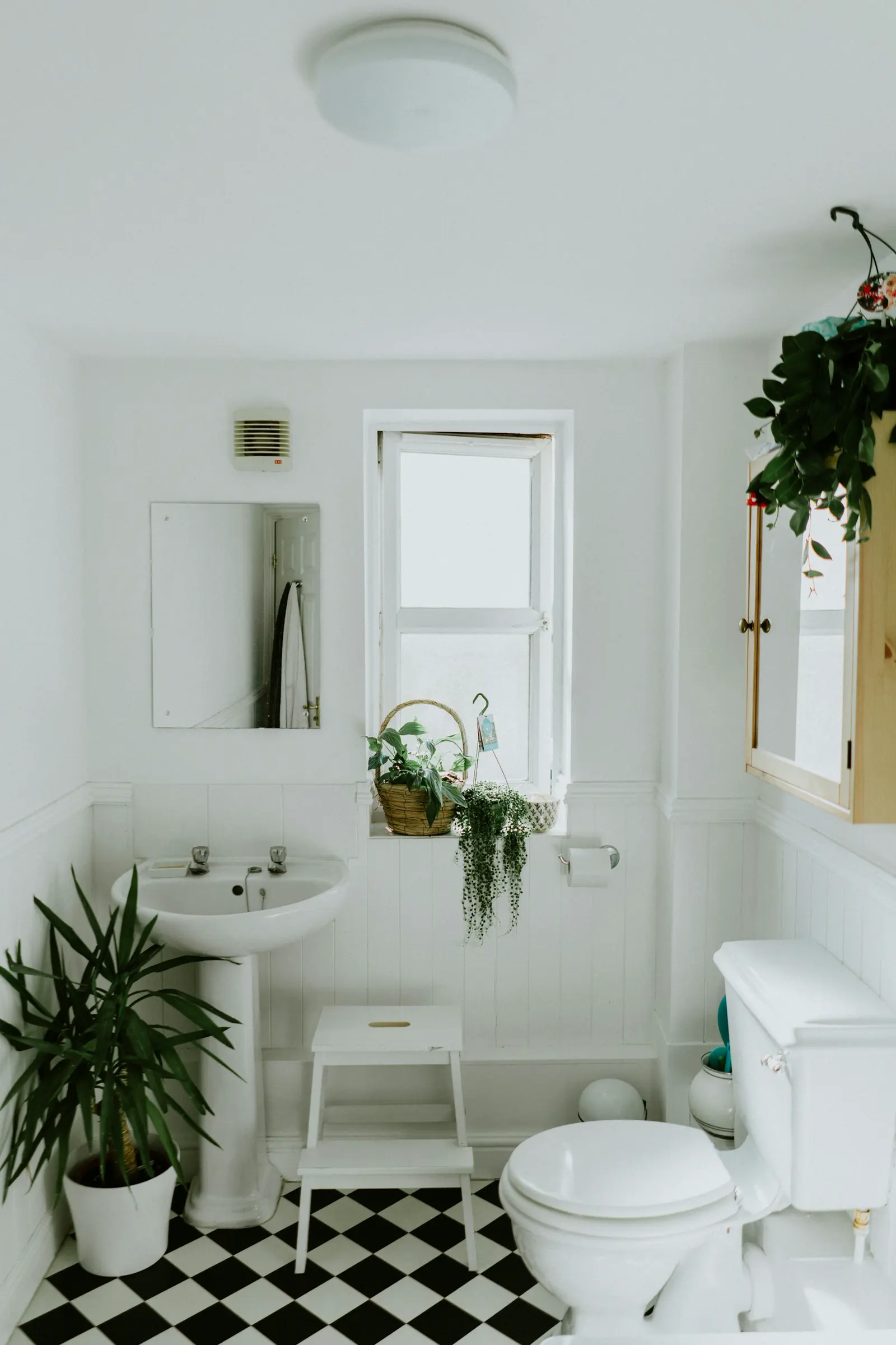 Stock photo of a modern white bathroom vanity and tile, used to illustrate hidden moisture and leak detection