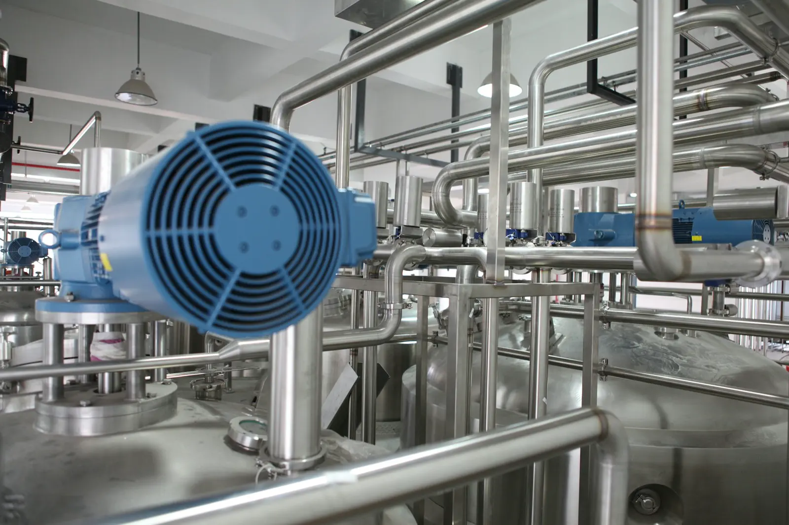 Stock photo of industrial piping in a plant setting, used to illustrate sewer and waste-line infrastructure