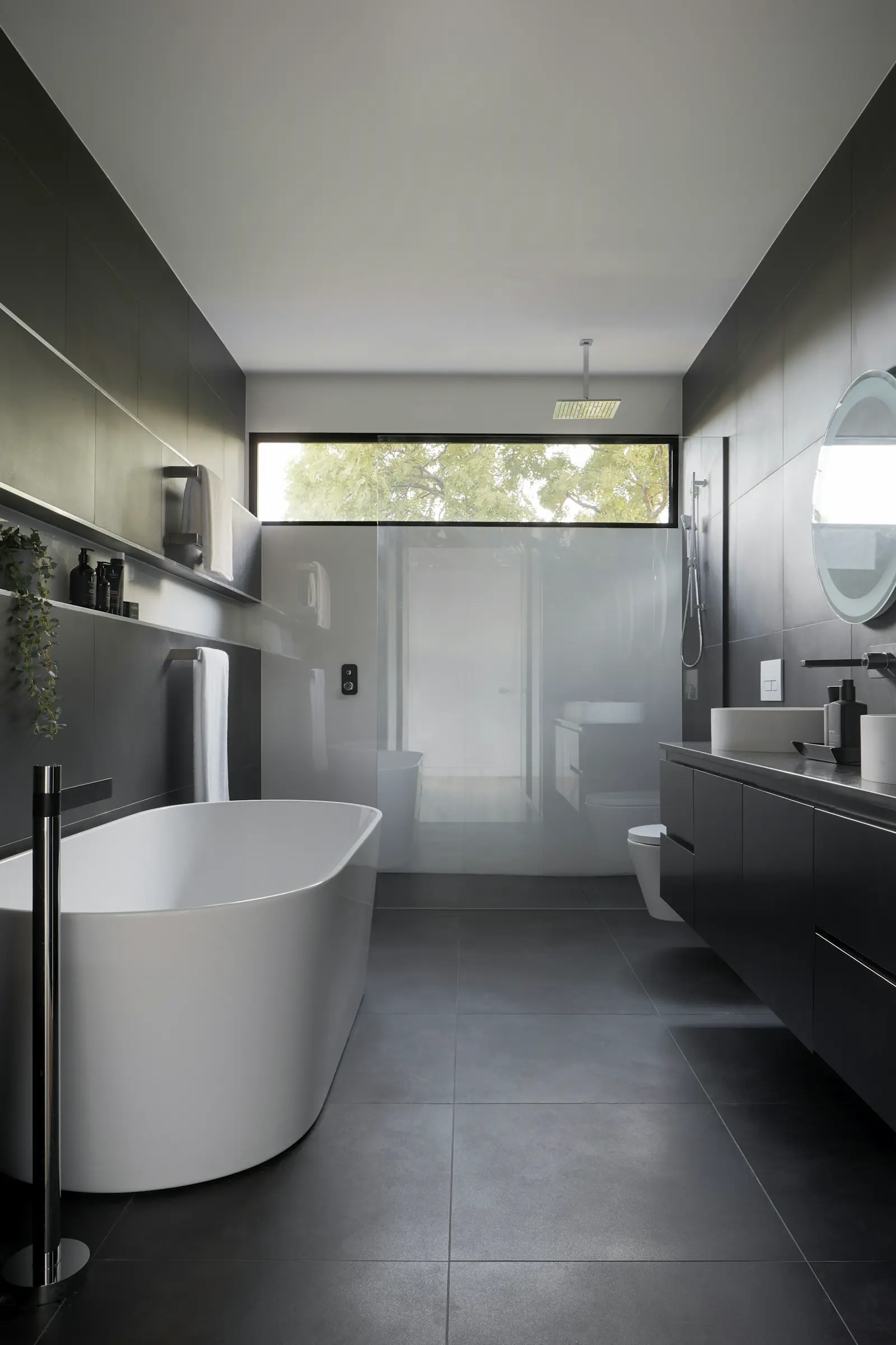 Stock photo of a tiled walk-in shower, used to illustrate bathroom plumbing and toilet repair visits
